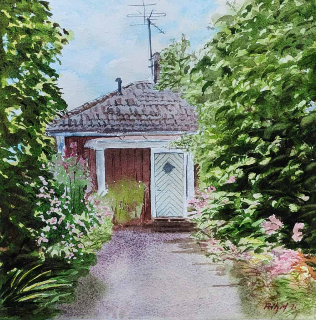 Röd stuga med syrener.